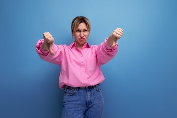 young european blonde secretary woman dressed in a pink shirt shows dislike