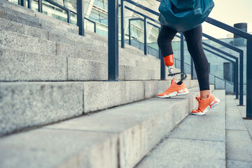 Sport is my way of life. Cropped photo of woman with leg prosthesis in sports clothing carrying her...
