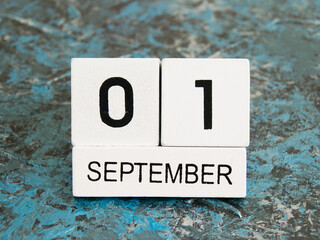 Wooden calendar on a dark background. The date is September 1, the Day of Knowledge.