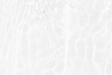 White water with ripples on the surface. Defocus blurred transparent white colored clear calm water surface texture with splashes and bubbles. Water waves with shining pattern texture background.