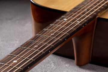 Fototapeta premium Classical guitar close up. Acoustic guitar on wood background.Music instrument concept
