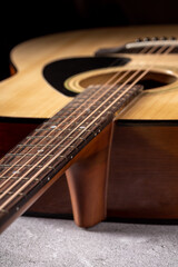Fototapeta premium Classical guitar close up. Acoustic guitar on wood background.Music instrument concept
