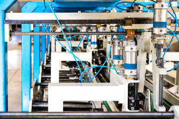 The line of assembly of cardboard packaging in boxes and finished products. Mechanism and production industry