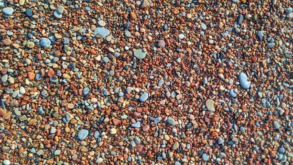 Pebble beach. Multi-colored pebbles of the sea. View from above.