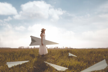 surreal woman surrounded by giant paper airplanes; abstract concept