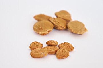 Apricot kernels on a background of seeds. Selective focus. Vitamin B 17. Healthy food background. Side view