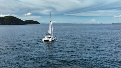Fototapeta premium Aerial view of a catamaran on the andaman seas. Sailing in Phuket, Thailand.