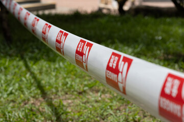 Prohibited access tape on the lawn of the residential building.
