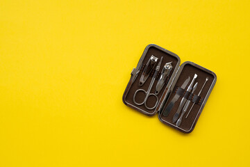 Manicure set on a yellow background close-up
