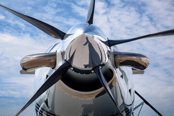 Detail of the spinner, blades, exhaust and intake of a turboprop aircraft. Chrome nose cone and...