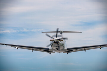 A Pilatus PC-12 as seen from the front in flight