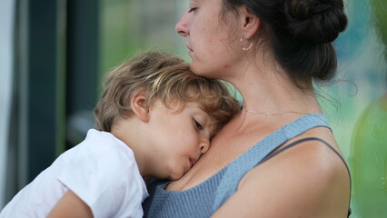 Sleepy child and mother tired parent and kid waiting together pensive woman holding small boy