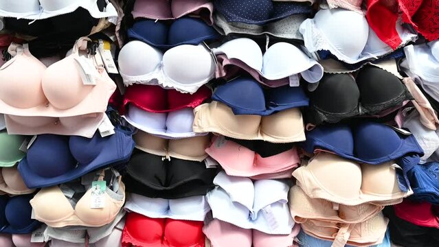Bras for sale in market. Colorful female bra on stall in shop. 