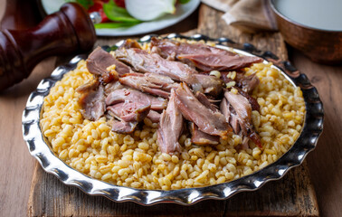 Turkish foods; lamb shank tandoori on bulgur wheat rice (Turkish name; bulgur bugday pilavi kuzu incik tandir)