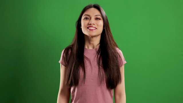 Asian Beauty with a confident smile in a studio - extreme slow motion shot