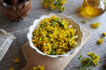 Fresh St. John's wort blossoms in a white bowl