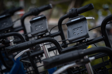 The black phone holder of a public bicycle is parked on the street.