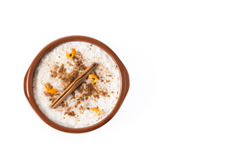 Arroz con leche. Rice pudding with cinnamon in clay bowl isolated on white background. Copy space