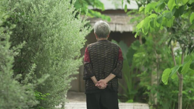 old elderly elder senior woman waking relaxing in garden
