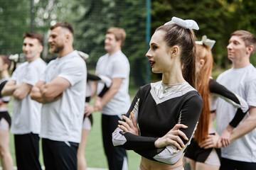 Young cheerleading girl taking part in performance together with her team