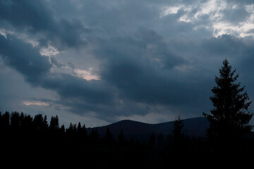 Night in mountains. Silhouette against the sky