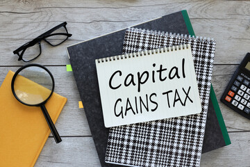 top view of a notebook on a folder. text on the page capital gains tax