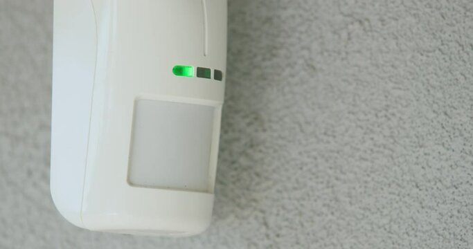 Motion sensor on the wall of the house. LED indicators light up to detect movement