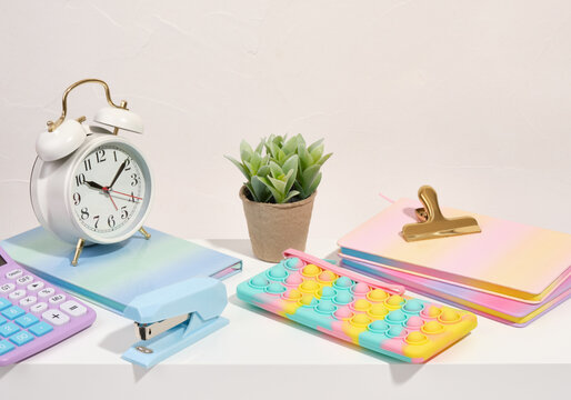 Colorful school stationery. Pencil case, notepads, calculator and alarm clock.