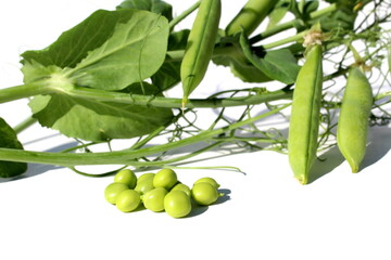 Green Peas pod and peas lie on a white isolated background.	