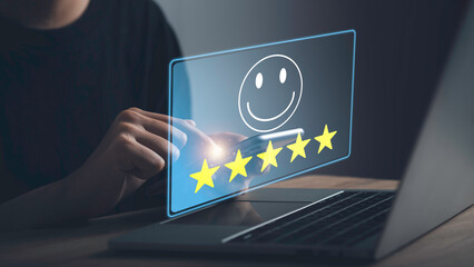 Customer Experience feedback concept. Businessman give five stars with smiley face for the best excellent evaluation of satisfaction; service like; Good quality; High rating; very good by laptop.