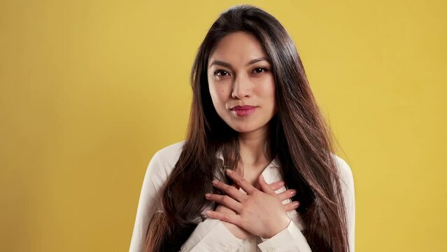 Asian Girl with a confident smile in a studio is happy and thankful - extreme slow motion shot