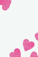 Obraz premium Frame made of pink glittering hearts. Festive concept on a blue background.