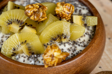 yogurt with the addition of pieces of ripe yellow kiwi with chia and popcorn