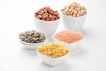 Multiple legumes and beans in bowl isolated on white background