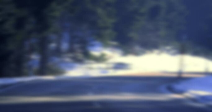 A blue car speeds through mountains, showcasing reliable transportation. Motion blur adds to the dynamic scene.