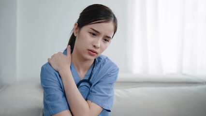 Young asian woman nurse feeling tired and depressed, suffering with neck pain after hard working....