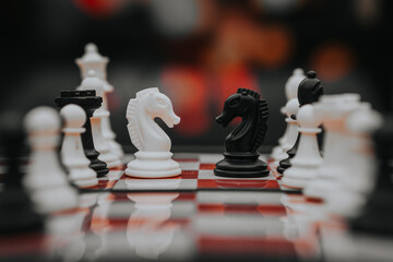 chess knight figure in competition success play. strategy, management, or leadership concept. knight challenge center. Pieces on the chessboard. falling pieces on chessboard  © sumblistan