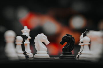 chess knight figure in competition success play. strategy, management, or leadership concept. knight challenge center. Pieces on the chessboard. falling pieces on chessboard  © sumblistan