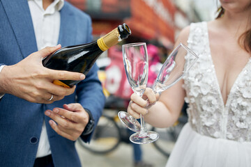 bride and groom holding champagne glasses
