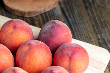 Ripe fresh peaches on a wooden table