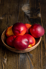 Nectarines folded in a wooden bowl