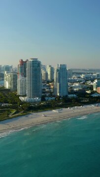 Aerial footage of Miami South Beach and Miami harbor. Prestige residential ocean view beach front property USA. Modern buildings. Real Estate business footage, drone 4K. Vertical video background. 