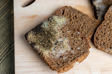 Black rye bread in mold on the board