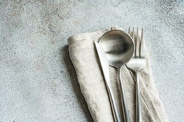 Set of cutlery placed on towel napkin
