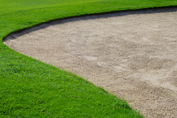 Golf Course Sand Pit Bunkers, green grass surrounding the beautiful sand holes is one of the most challenging obstacles for golfers and adds to the beauty of the golf course.