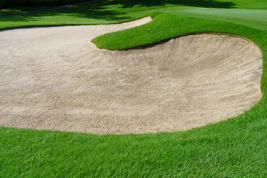 Golf Course Sand Pit Bunkers, green grass surrounding the beautiful sand holes is one of the most challenging obstacles for golfers and adds to the beauty of the golf course.