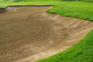 Golf Course Sand Pit Bunkers, green grass surrounding the beautiful sand holes is one of the most challenging obstacles for golfers and adds to the beauty of the golf course.