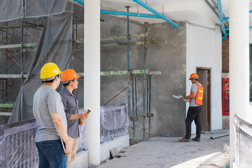 Team of architect working together in building construction site. They discussing about new startup project. Engineer, foreman, Architect, contractor and worker in building construction site.