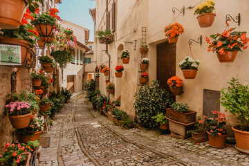 narrow flower street in the city of spello in italy
