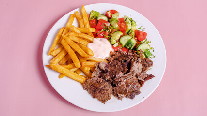 Beef portion doner kebab with fries in plate